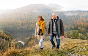 Senior couple walking in the mountains to help arthritis