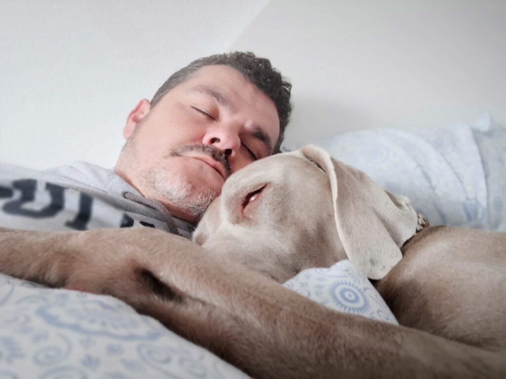 man asleep with his dog